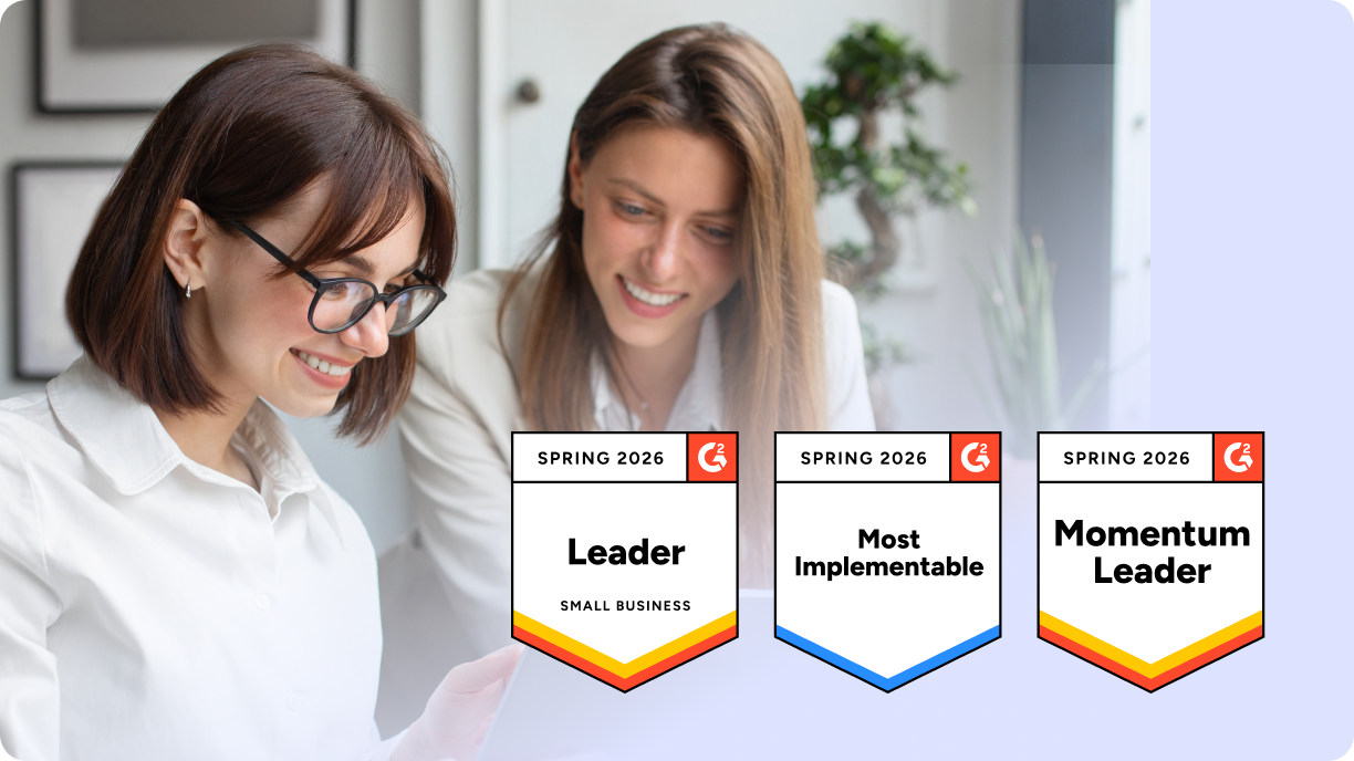 Two women smiling at a laptop, with G2 Spring 2026 badges showing CloudTalk as a G2 Leader in Contact Center Software for Small Businesses.